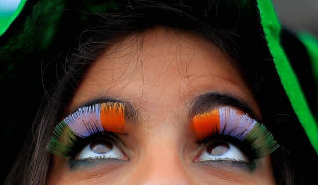 A woman wears false flag eyelashes during the St Patrick's day parade through Dublin city centre on St Patrick's day, on March 17, 2013. (Photo by Julien Behal/PA Wire)