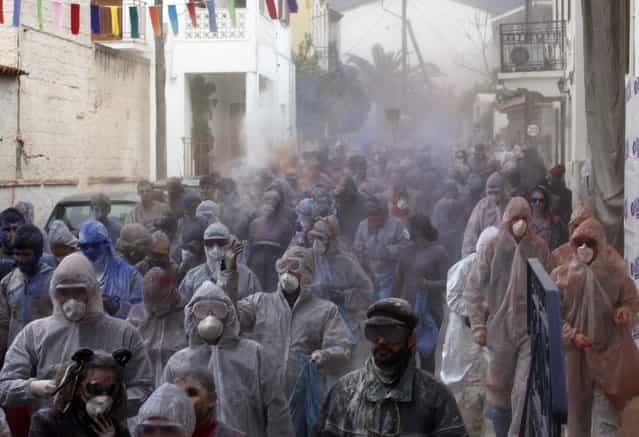 Revellers celebrate "Ash Monday" by participating in a colourful "flour war", a traditional festivity marking the end of the carnival season and the start of the 40-day Lent period until the Orthodox Easter,in the port town of Galaxidi, some 215 km (134 miles) north west of Athens, March 18, 2013. The revellers "fight" by throwing coloured flour, charcoal dust and powder painting until they essentially run out of supplies. (Photo by Yannis Behrakis/Reuters)