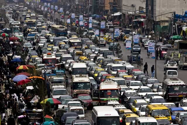 Traffic fills a street, before the celebration of the Persian New Year Nowruz in Kabul, Afghanistan, Wednesday, March 20, 2013. Nowruz marks the first day of spring and the beginning of the year on the Iranian calendar. (Photo by Ali Hamed Haghdoust/AP Photo)