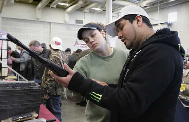 Maria and Jose Martinez, of Hartford, look over rifles at the Washington County Fairgrounds Gun Show, on March 22, 2013. The Martinez' showed up because they heard there may be a scarcity of weapons, with the upcoming push for gun legislation. (Photo by Gary Porter)