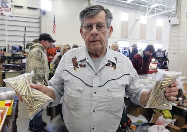 Roland Blanke, of Sheboygan Falls holds .223 gauge shells that he says are becoming scarce because of an ammo shortage, at the Washington County Fairgrounds Gun Show that drew thousands of people over the weekend, on March 22, 2013. (Photo by Gary Porter)