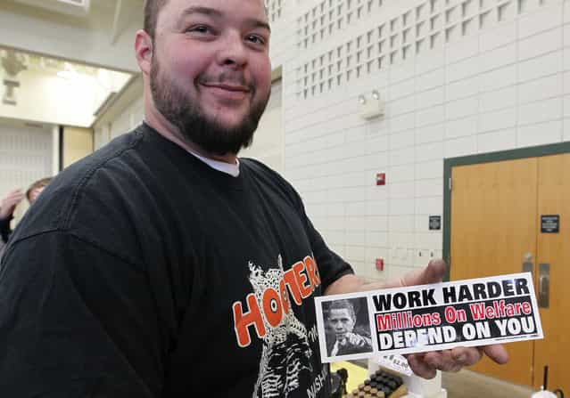 Jim Green of Hartford shows a bumper sticker he plans on buying at the Washington County Fairgrounds Gun Show, on March 22, 2013. The show drew thousands of people over the weekend. (Photo by Gary Porter)