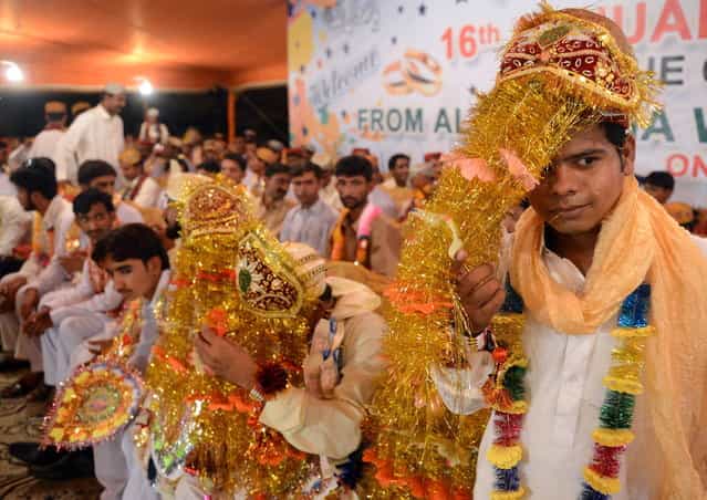 Pakistani grooms attend a mass marriage ceremony in Karachi late March 26, 2013. Some 110 couples participated in the mass wedding ceremony organised by a local charity welfare trust Al Ghousia. (Photo by Asif Hassan/AFP Photo)