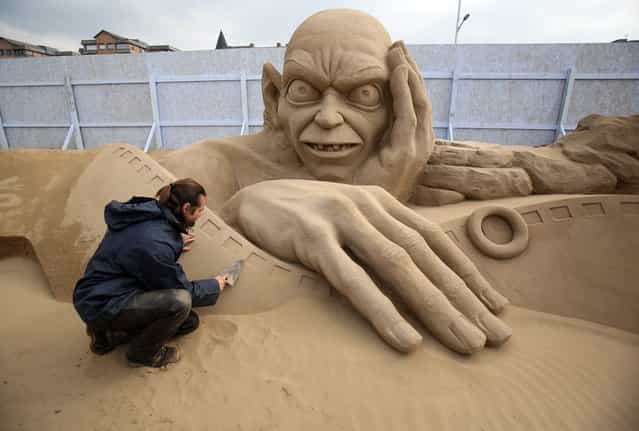 Sand sculptor Radavan Zivny works on a sand sculpture of Gollum as pieces are prepared as part of this year's Hollywood themed annual Weston-super-Mare Sand Sculpture festival on March 26, 2013 in Weston-Super-Mare, England. Due to open on Good Friday, currently twenty award winning sand sculptors from across the globe are working to create sand sculptures including Harry Potter, Marilyn Monroe and characters from the Star Wars films as part of the town's very own movie themed festival on the beach. (Photo by Matt Cardy)