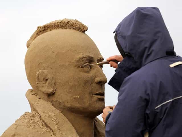 A sand sculptor works on a Robert De Niro in Taxi Driver sand sculpture as pieces are prepared as part of this year's Hollywood themed annual Weston-super-Mare Sand Sculpture festival on March 26, 2013 in Weston-Super-Mare, England. Due to open on Good Friday, currently twenty award winning sand sculptors from across the globe are working to create sand sculptures including Harry Potter, Marilyn Monroe and characters from the Star Wars films as part of the town's very own movie themed festival on the beach. (Photo by Matt Cardy)