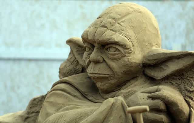 Detail of a sand sculpture of Yoda is seen as pieces are prepared as part of this year's Hollywood themed annual Weston-super-Mare Sand Sculpture festival on March 26, 2013 in Weston-Super-Mare, England. Due to open on Good Friday, currently twenty award winning sand sculptors from across the globe are working to create sand sculptures including Harry Potter, Marilyn Monroe and characters from the Star Wars films as part of the town's very own movie themed festival on the beach. (Photo by Matt Cardy)