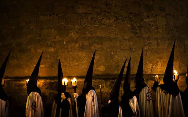 Penitents from [Jesus en su Tercera Caida] brotherhood wait in their church to take part in a procession in Zamora, Spain, on March 25, 2013. Hundreds of processions take place throughout Spain during the Easter Holy Week. (Photo by Daniel Ochoa de Olza/Associated Press)