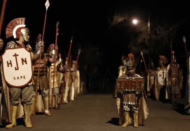 A boy dressed up as a Roman soldier takes part in a procession during Holy Week, in Tapachula, near San Jose, Costa Rica, on March 27, 2013. Holy Week is celebrated in many Christian traditions during the week before Easter. (Photo by Juan Carlos Ulate/Reuters)