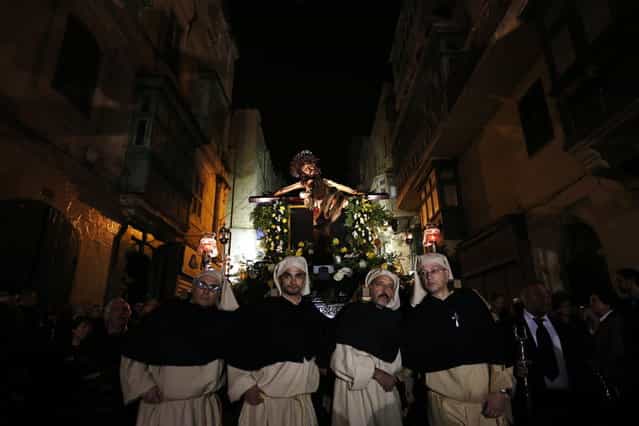 The [miraculous] Ta' Giezu (of Jesus) crucifix is carried during the Via Crucis, the Way of the Cross, during Holy Week in Valletta March 27, 2013. Legend has it that in 1630, the artist Fra Umile had racked his brains to try and depict Christ at his greatest hour of pain, but while he slept the head of Christ was completed by an angel. Holy Week is celebrated in many Christian traditions during the week before Easter. (Photo by Darrin Zammit Lupi/Reuters)