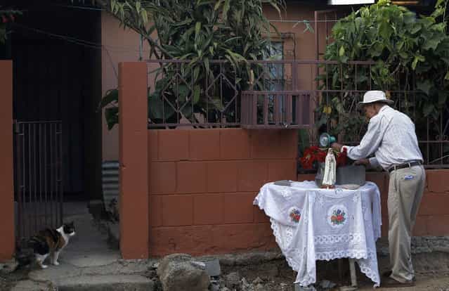 A man prepares an altar outside his house before a Holy Week procession in Tapachula, near San Jose, March 27, 2013. Holy Week is celebrated in many Christian traditions during the week before Easter. (Photo by Juan Carlos Ulate/Reuters)