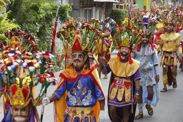 Penitents take part in a procession for the Moriones Festival during Holy Week in Mogpog town on Marinduque island, central Philippines March 27, 2013. During the annual festival, masked and costumed penitents called [Moriones] dress in attire that is the local interpretation of what Roman soldiers wore during biblical times. Holy Week is celebrated in many Christian traditions during the week before Easter. (Photo by Erik De Castro/Reuters)