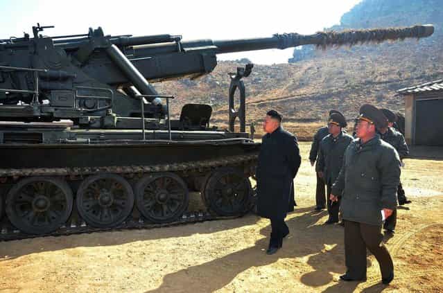 This undated picture released by North Korea's official Korean Central News Agency on March 12, 2013 shows North Korean leader Kim Jong Un (C) inspecting a long-range artillery sub-unit of Korean People's Army Unit 641 at undisclosed place in North Korea. (Photo by AFP Photo/KCNA via KNS)