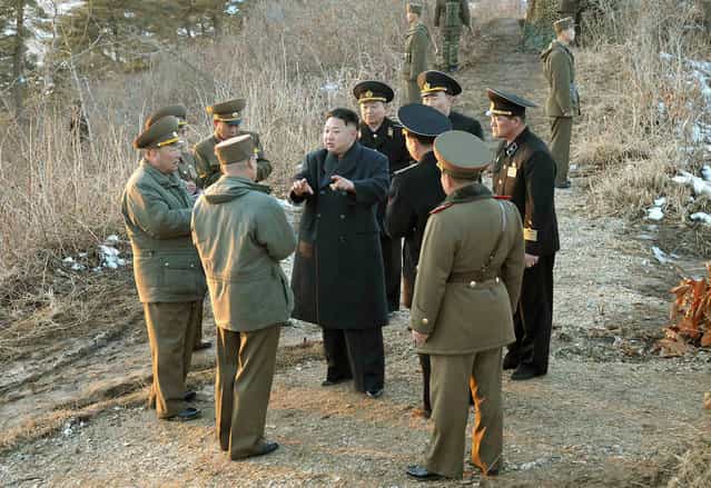 This picture released by North Korea's official Korean Central News Agency on March 26, 2013 and taken on March 25, 2013 shows North Korean leader Kim Jong Un speaking with military officials during his inspection of the landing and anti-landing drills of KPA Large Combined Units 324 and 287 and KPA Navy Combined Unit 597 at an undisclosed location on North Korea's east coast. (Photo by AFP Photo/KCNA via KNS)