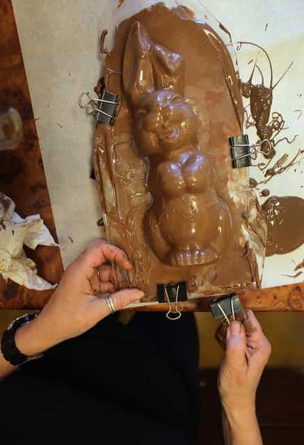 Darlene Eddy uses a mold to make a chocolate Easter bunny in her store Amazing Chocolates on March 28, 2013 in Hollywood, Florida. Americans spend roughly $1.9 billion on Easter candy, second only to Halloween in candy consumption. Around ninety million chocolate Easter bunnies are produced each year, from white to dark chocolate, and with an unlimited varieties of styles. (Photo by Joe Raedle)