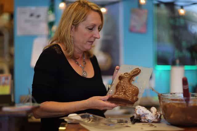 Darlene Eddy uses a mold to make a chocolate Easter bunny in her store Amazing Chocolates on March 28, 2013 in Hollywood, Florida. Americans spend roughly $1.9 billion on Easter candy, second only to Halloween in candy consumption. Around ninety million chocolate Easter bunnies are produced each year, from white to dark chocolate, and with an unlimited varieties of styles. (Photo by Joe Raedle)