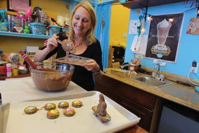 Darlene Eddy pours chocolate into a mold to make a chocolate Easter bunny in her store Amazing Chocolates on March 28, 2013 in Hollywood, Florida. Americans spend roughly $1.9 billion on Easter candy, second only to Halloween in candy consumption. Around ninety million chocolate Easter bunnies are produced each year, from white to dark chocolate, and with an unlimited varieties of styles. (Photo by Joe Raedle)