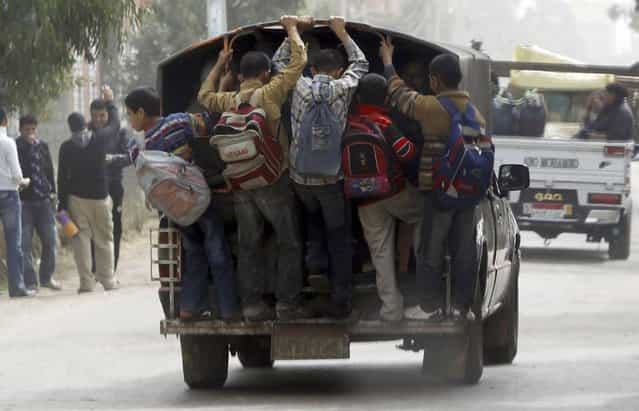 Students travel in a vehicle after attending school at Ibsheway el-Malaq village in Gharbia governorate, about 165 km (103 miles) northeast of Cairo, March 12, 2012. (Photo by Amr Abdallah Dalsh/Reuters)