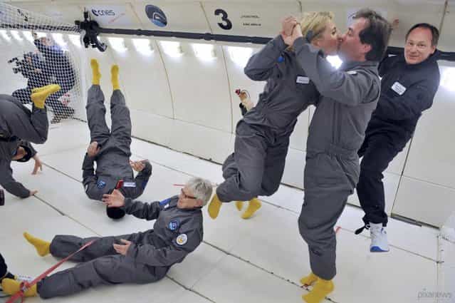 Civilian passengers in an Airbus A330 Zero-G jet enjoy moments of weightlessness on March 15, 2013 during the first zero-gravity airplane flight for paying passengers in France. All of the available slots for 2013 and 2014 were sold out, at a cost of 6,000 euros per person. The airplane ride simulates the microgravity of orbital space missions by going through parabolic flight maneuvers that counter the force of gravity. (Photo by Mehdi Fedouach/AFP Photo)