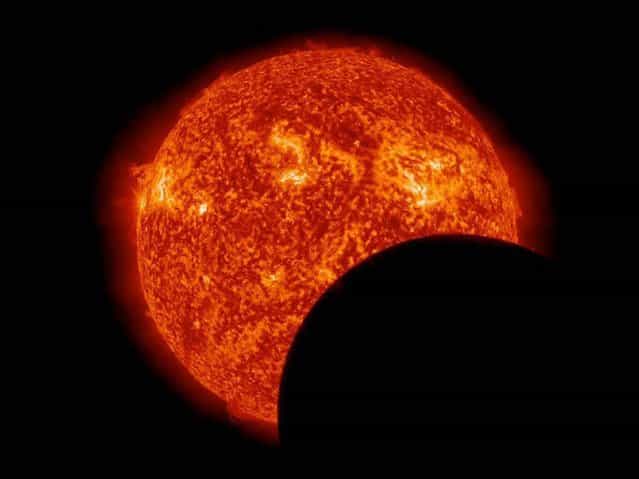NASA's Solar Dynamics Observatory caught this view of the moon crossing in front of the sun on March 11, 2013. The transit took place during the sun-observing probe's semiannual eclipse season, a period of three weeks when SDO's view of the sun is occasionally blocked by Earth or the moon. (Photo by NASA via EPA)