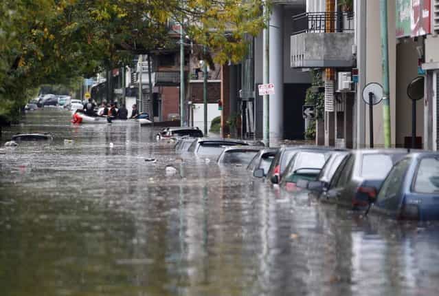Submerged cars are seen in a flooded street after a rainstorm in Buenos Aires April 2, 2013. Thunderstorms damaged property and vehicles, cut power and caused delays on flights in Buenos Aires and its suburbs. The City's SAME emergency service announced that the death toll has risen to five. (Photo by Enrique Marcarian/Reuters)