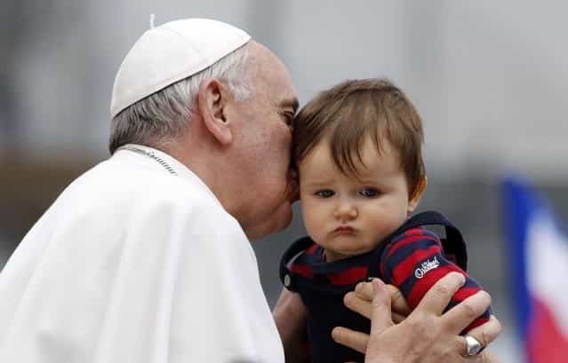 Pope Francis kisses a child during a weekly general audience in Saint Peter's Basilica, at the Vatican April 3, 2013. (Photo by Stefano Rellandini/Reuters)