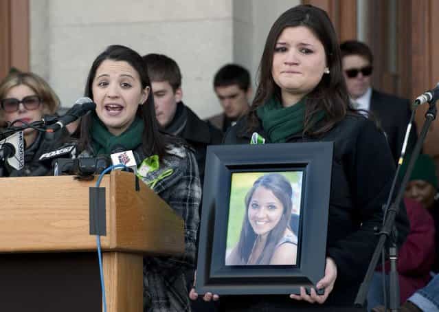 Jillian Soto, sister of Sandy Hook Elementary School shooting victim Victoria Soto, left, speaks as her cousin Heather Cronk, right, holding photograph of Soto, listens, during a rally at the Capitol in Hartford, Conn., Thursday, February 14, 2013. Thousands of people turned out to call on lawmakers to toughen gun laws in light of the December elementary school shooting in Newtown that left 26 students and educators dead. (Photo by Jessica Hill/AP Photo)