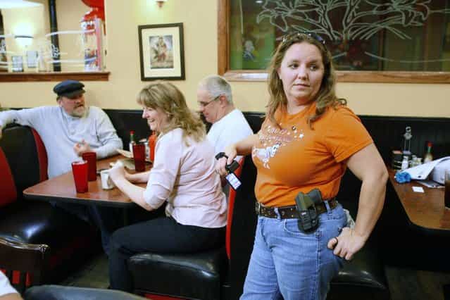 Morgan Meritt of Del City, Oklahoma, joins other members of the Oklahoma Open Carry Association (OKOCA) wearing unconcealed side arms as they gather at Beverly's Pancake House in Oklahoma City November 1, 2012. A new Oklahoma law took effect November 1 allowing anyone with a concealed weapon license to carry their firearms openly in a holster or belt. (Photo by Bill Waugh/Reuters)