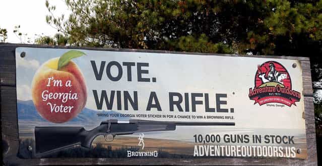 One of several billboards of a gun raffle promotion at Adventures Outdoors in Smyrna, Georgia, October 25, 2012. The store has promoted the raffle on billboards as a [Vote. Win a rifle]. but owner Jay Wallace has stated that all Georgia residents are eligible to enter. (Photo by Tami Chappell/Reuters)
