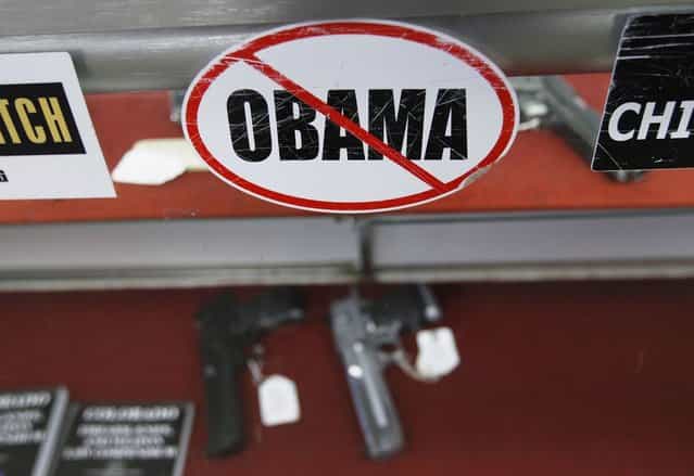 A sticker is seen at the Rocky Mountain Guns and Ammo store in Parker, Colorado July 24, 2012. The killing of 12 people at a midnight screening of the new Batman movie in the Denver suburb of Aurora may spark a fresh round of soul-searching on America's relationship with guns but few predict any real change in the law. (Photo by Shannon Stapleton/Reuters)