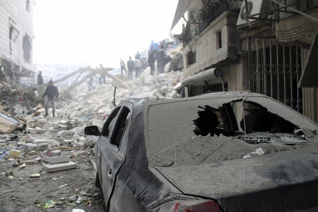 A damaged car in rubble in Al-Ansari neighborhood after what activists said was a missile attack by Syrian Air Forces in Aleppo, on February 3, 2013. (Photo by Aaref Hretani/Reuters /The Atlantic)