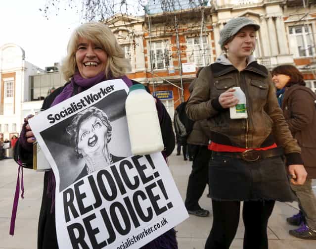 Revellers hold up posters and cartons of milk to celebrate the death of Britain's former prime minister Margaret Thatcher in Brixton, south London April 8, 2013. Margaret Thatcher, the [Iron Lady] who transformed Britain and inspired conservatives around the world by radically rolling back the state during her 11 years in power, died on Monday following a stroke. She was 87. (Photo by Olivia Harris/Reuters)