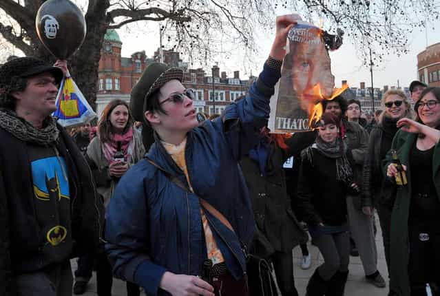 A woman burns a newspaper page showing an image of former British Prime Minister Margaret Thatcher during a [party] to celebrate the death of Margaret Thatcher in London, on April 8, 2013. Margaret Thatcher, the [Iron Lady] who shaped a generation of British politics, died following a stroke on Monday at the age of 87, her spokesman said. (Photo by Carl Court/AFP Photo)