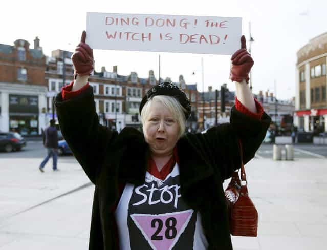 A reveller holds a sign to celebrate the death of Britain's former prime minister Margaret Thatcher, at a party in Brixton, south London April 8, 2013. Margaret Thatcher, the [Iron Lady] who transformed Britain and inspired conservatives around the world by radically rolling back the state during her 11 years in power, died on Monday following a stroke. She was 87. (Photo by Olivia Harris/Reuters)