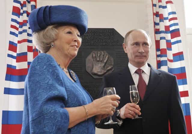Russian President Vladimir Putin and Queen Beatrix of the Netherlands toast after they unveiled a plaquette with hand imprint of Peter the Great, during a tour of the Amsterdam Hermitage Museum April 8, 2013. (Photo by Alexei Druzhinin/Reuters/RIA Novosti)