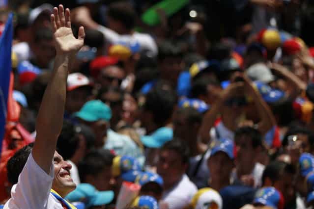 Venezuela's opposition leader and presidential candidate Henrique Capriles greets supporters during a campaign rally in the state of Guarico April 8, 2013. Venezuela will hold presidential elections on April 14. (Photo by Carlos Garcia Rawlins/Reuters)