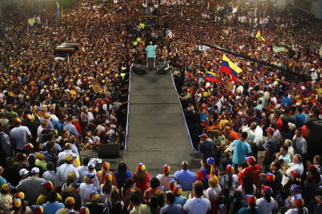 Venezuela's opposition leader and presidential candidate Henrique Capriles (C) speaks to supporters during a campaign rally in the state of Zulia April 10, 2013. (Photo by Carlos Garcia Rawlins/Reuters)