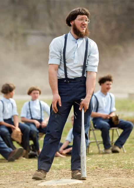 Freeman Burkholder waits for his at bat during a game of baseball at the farewell picnic in Bergholz, Ohio on Tuesday, April 9, 2013. The picnic was for Burkholder and other Amish people leaving for prison this week for their part in the hair and beard cutting scandal against other Amish members. (Photo by Scott R. Galvin/AP Photo)