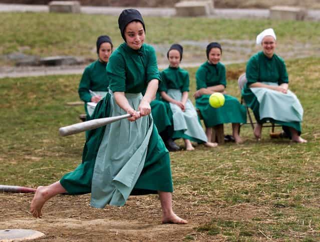 Amish girls play softball after class during an end of the school year celebration on Tuesday, April 9, 2013 in Bergholz, Ohio. The celebration was also part of a farewell picnic for four women and one man from this tight-knit group in rural eastern Ohio who will enter prison on Friday, April 12, joining nine already behind bars on hate crimes convictions for hair- and beard-cutting attacks against fellow Amish. (Photo by Scott R. Galvin/AP Photo)