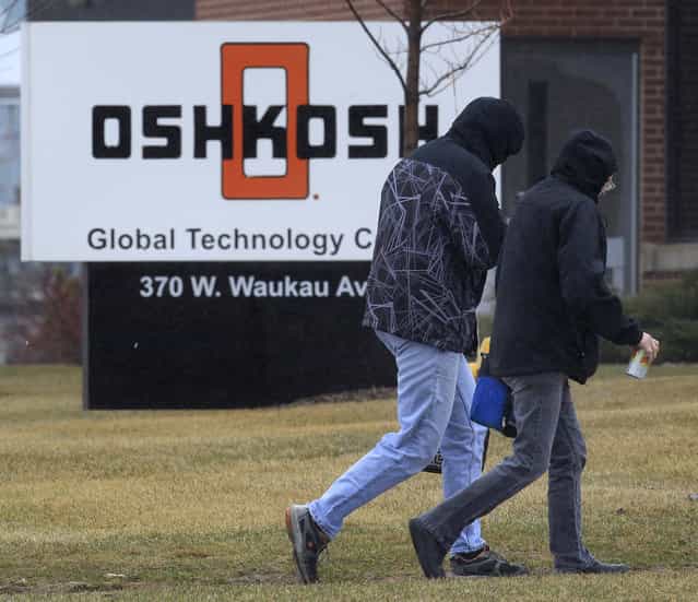 Oshkosh Corp. workers arrive Thursday, April 11, 2013 in Oshkosh, Wis. Faced with deep cuts in U.S. military spending, and the end of the wars in Iraq and Afghanistan, Oshkosh Corp. is laying off 900 employees in its defense division based in Oshkosh. Approximately 700 hourly workers at the state's largest manufacturer will lose their jobs in mid-June, followed by approximately 200 salaried employees through July. (Photo by Mark Hoffman via The Journal Sentinel)