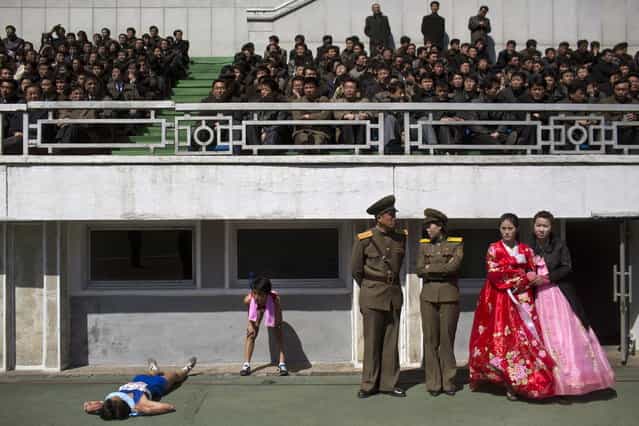 Runners rest inside Kim Il Sung Stadium in Pyongyang, North Korea on Sunday, April 14, 2013. North Korea hosted the 26th Mangyongdae Prize Marathon to mark the upcoming April 15, 2013 birthday of the late leader Kim Il Sung. (Photo by Alexander F. Yuan/AP Photo)