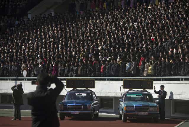 Cars with timing clocks wait for the start of a marathon to begin at Kim Il Sung Stadium in Pyongyang on Sunday, April 14, 2013. North Korea hosted the 26th Mangyongdae Prize Marathon to mark the upcoming April 15, 2013 birthday of the late leader Kim Il Sung. (Photo by David Guttenfelder/AP Photo)