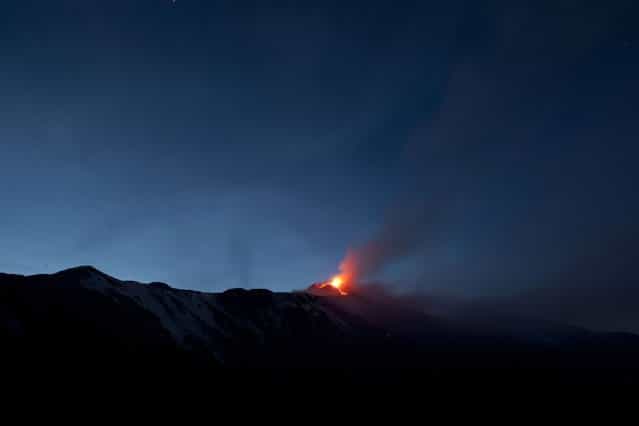 Italy's volcanic Mount Etna spews lava during an eruption on the southern Italian island of Sicily April 11, 2013. Mount Etna is Europe's tallest and most active volcano. Picture taken April 11, 2013. (Photo by Antonio Parrinello/Reuters)