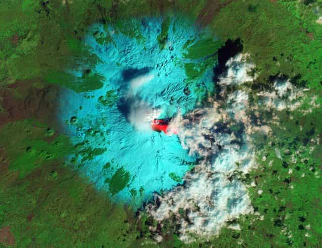 Italy's Etna Volcano is seen erupting in this false-color handout image taken with the Advanced Land Imager (ALI) on NASA's Earth Observing-1 (EO-1) satellite at 08:59 GMT February 19, 2013. Each outburst, or paroxysm, featured emission of lava flows, pyroclastic flows, lahars, and an ash cloud,according to the Italian Istituto Nazionale di Geofisica e Vulcanologia (INGV). The false-color image combines shortwave infrared, near infrared, and green light in the red, green, and blue channels of an RGB picture. Fresh lava, erupted hours earlier, is seen as bright red. (Photo by Jesse Allen/Robert Simmon/Reuters/NASA EO-1 ALI)