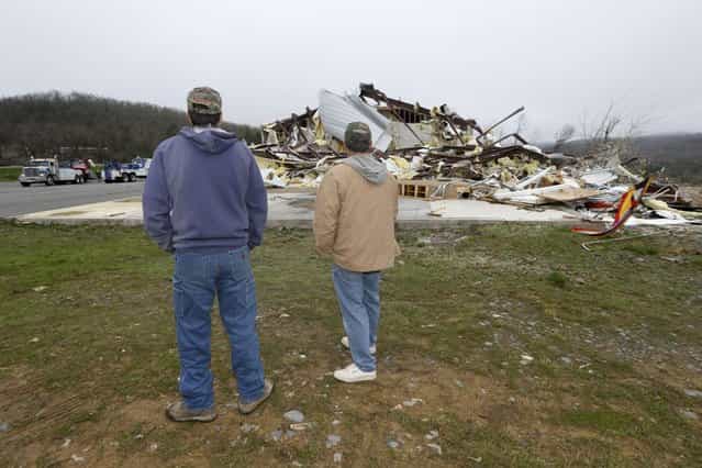 Larry Gammill, left, and Tim Parks survey tornado damage at Botkinburg Foursquare Church in Botkinburg, Ark., Thursday, April 11, 2013, after a severe storm struck the building late Wednesday. The National Weather Service is surveying areas Thursday to determine whether tornadoes or strong winds caused damage. (Photo by Danny Johnston/AP Photo)
