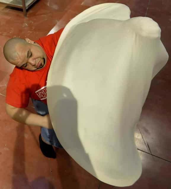 Flores Rodriguez, of Puerto Rico, performs with his dough during the freestyle event, part of the Pizza World Championships, in Parma, northern Italy, Wednesday, April 17, 2013. The 22th edition of the championships run from April 15 to April 17. (Photo by Marco Vasini/AP Photo)