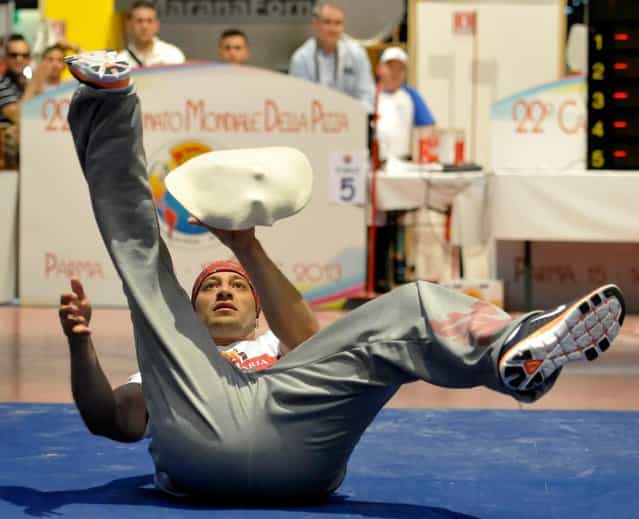 Juan Ramirez Hermosillo, of Mexico, performs with his dough during the acrobatic pizza event, part of the Pizza World Championships, in Parma, Italy, Wednesday, April 17, 2013. (Photo by Marco Vasini/AP Photo)