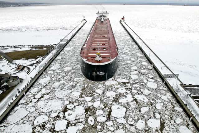 The American Integrity enters the Duluth ship canal after ice on Lake Superior blocked access to the Duluth Superior harbor, causing nine ships to wait at anchor in the open lake until ice breaking operations could open a lane for the traffic, on April 13, 2013. (Photo by Clint Austin/Duluth News Tribune)