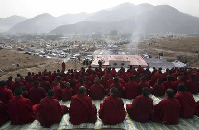 Tibetan Buddhist monks attend a mass prayer in memorial for victims of the earthquake which hit Yushu county three years ago, in Yushu, Qinghai province April 14, 2013. The 7.1-magnitude earthquake that jolted Yushu of northwest China's Qinghai Province three years ago caused 2,698 people dead and 270 missing. Picture taken April 14, 2013. (Photo by Reuters/Stringer)