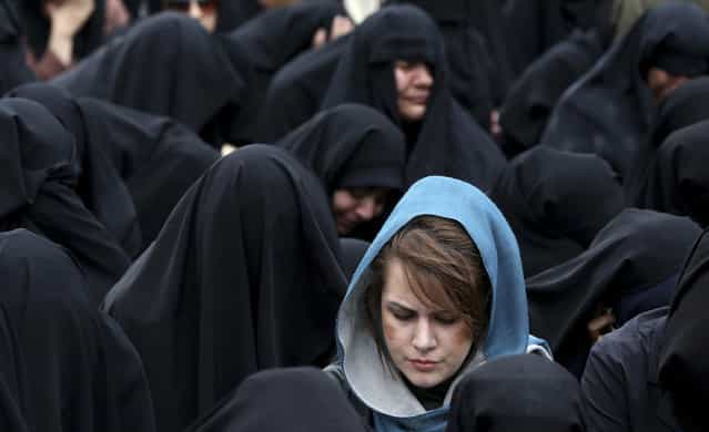 Iranian women attend a mourning ceremony marking the death anniversary of Fatima, the daughter of Islam's Prophet Muhammad, in Tehran, Iran, Sunday, April 14, 2013. (Photo by Ebrahim Noroozi/AP Photo)