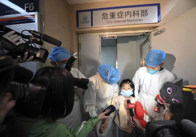 A girl, who was previously infected with the H7N9 bird flu virus, talks to the media as she is transferred from the ICU to a public ward at Ditan hospital in Beijing April 15, 2013. According to a hospital spokesperson, the H7N9 virus is no longer detected in the girl's body. Two people in the central Chinese province of Henan have been infected by the new strain of avian influenza, the first cases found in the region, while the death toll has risen to 13 from a total of 60 infections after two more deaths in Shanghai. (Photo by Reuters/Stringer)